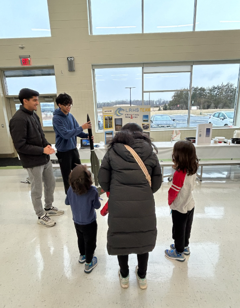 Team members sharing rocketry with families