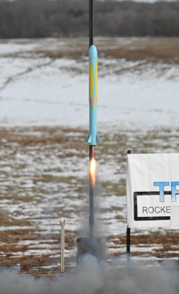 Blue and yellow rocket lifting off